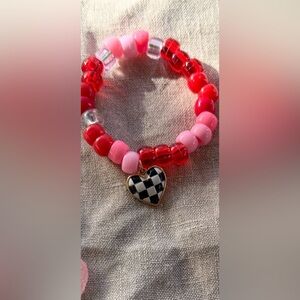 Cute bracelet  with black and white checkered heart .